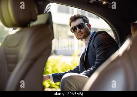 Businessman getting in the car Stock Photo