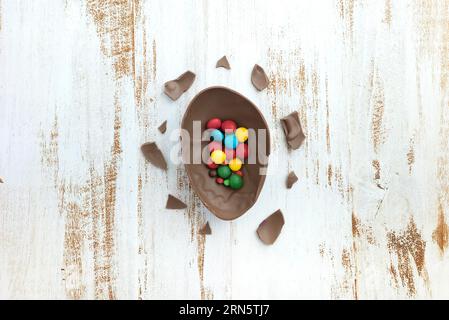 Small candies open chocolate egg table Stock Photo