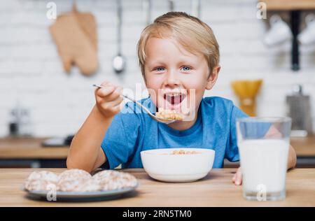 Smiley kid eating cereal Stock Photo