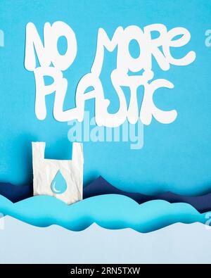 Top view paper ocean waves with plastic bag message Stock Photo