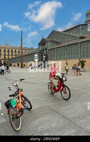 Barcelona - August 31, 2023: Man on rental electric bicycle available to citizens in Barcelona. Stock Photo