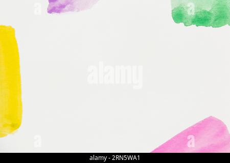 Yellow pink green purple brush stroke white backdrop with space writing text Stock Photo