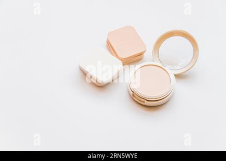 Close up cosmetic realistic plastic compact powder with sponges white backdrop Stock Photo