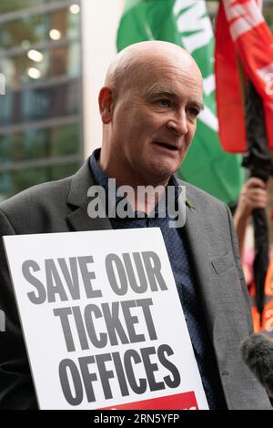 London, UK. 31 August, 2023. Mick Lynch, leader of RMT transport union, joins opponents of train station ticket office closures  outside the Department for Transport (DfT) before marching to Downing Street as the DfT managed train companies plan widespread closures. Organised by the RMT union and supported by disability rights groups, opponents see closures as a cost cutting measure for the benefit of private train operators, leading to job cuts, increased ticket prices, decreased safety and accessibility for disabled passengers. Credit: Ron Fassbender/Alamy Live News Stock Photo