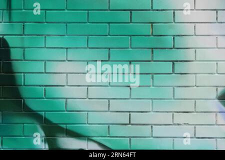 green painted brick wall , graffiti background Stock Photo