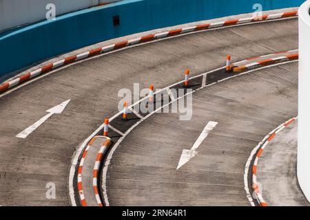 two lane road curve with direction arrows on asphalt Stock Photo