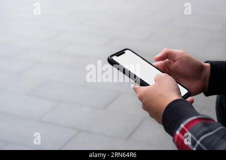 Holding mobile phone with copy space background Stock Photo