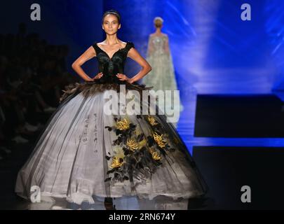 A model presents a creation by Chinese designer Laurence Xu in Milan, Italy, on July 13, 2015. As the closing event of Expo Milan 2015 s Nanjing Week, a Yunjin fashion show by Chinese designer Laurence Xu was presented here on Monday with thirty-seven suits of haute couture made from Yunjin, a traditional Chinese silk brocade made in Nanjing, which was inscribed on UNESCO S List Intangible Cultural Heritage in 2009. ) ITALY-MILAN-EXPO-LAURENCE XU-FASHION SHOW JinxYu PUBLICATIONxNOTxINxCHN   a Model Presents a Creation by Chinese Designers Laurence Xu in Milan Italy ON July 13 2015 As The CLOSI Stock Photo