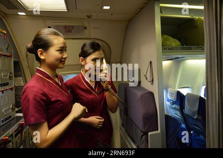 (150716) -- LANZHOU, July 16, 2015 -- Crew members of Flight CZ 6035 work in the cabin in Lanzhou Zhongchuan International Airport in Lanzhou, capital city of northwest China s Gansu Province, July 16, 2015. China Southern Airlines launched a new air route connecting Lanzhou, Urumqi and St. Petersburg on Thursday. The flight CZ6035/6 will be carried out by a plane of Boeing 757 every Monday, Tuesday, Thursday and Saturday. It has been so far the shortest flight from China s Urumqi to Russia s St. Petersburg with the travelling time of 5 hours. ) (mp) CHINA-LANZHOU-URUMQI-ST. PETERSBURG-FLIGHT Stock Photo