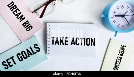 Dream big, set goals, take action, success recipe or reminder on colorful stickers on white background with clock Stock Photo