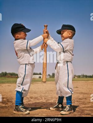 1960s TWO BOYS PITCHER AND CATCHER IN LITTLE LEague baseball