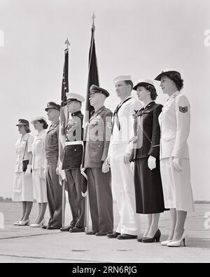 1950s MEN WOMEN DRESSED IN THE VARIOUS UNIFORMS OF THE AMERICAN MILITARY ARMY NAVY MARINES AIR FORCE STANDING WITH FLAGS - m3781 HAR001 HARS NAVY HEALTHINESS UNITED STATES COPY SPACE FULL-LENGTH LADIES PERSONS INSPIRATION UNITED STATES OF AMERICA MALES FORCE CONFIDENCE B&W NORTH AMERICA FREEDOM NORTH AMERICAN 8 ADVENTURE PROTECTION LEADERSHIP LOW ANGLE PRIDE OPPORTUNITY MARINES OCCUPATIONS PATRIOT UNIFORMS COLOR GUARD CONCEPTUAL PATRIOTIC STARS AND STRIPES STYLISH SUPPORT VARIOUS COOPERATION EIGHT PATRIOTISM RED WHITE AND BLUE YOUNG ADULT MAN YOUNG ADULT WOMAN BLACK AND WHITE Stock Photo