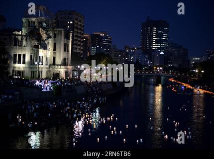 150806 -- HIROSHIMA, Aug. 6, 2015 -- Paper lanterns are seen floating on the Motoyasu river near the Atomic Bomb Dome after being released to grieve over atomic bomb victims of Hiroshima, western Japan, Aug. 6, 2015. Hiroshima, the city that suffered U.S. atomic bombing in 1945 during the World War Two, commemorated the 70th anniversary of the bombing on Thursday at the city s Peace Memorial Park, with its mayor calling for peace and elimination of nuclear weapons. azp JAPAN-HIROSHIMA-ATOMIC BOMBING-ANNIVERSARY maxping PUBLICATIONxNOTxINxCHN Stock Photo