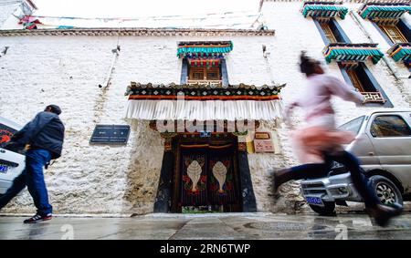 (150807) -- LHASA,  - People walk past Lincang, one of Lobsang Tashi s traditional Tibetan style hotels in Lhasa, capital of southwest China s Tibet Autonomous Region, Aug. 6, 2015. Born in a mountain village in Shannan Prefecture of Tibet, Lobsang Tashi has long harbored a deep love of the traditional culture of Tibet. In his youth, Lobsang came to the old town of Lhasa and worked as a tour guide. Driven by keen interest in protecting old buildings and culture of Lhasa, Lobsang Tashi got a chance to win a business right to renovate several old buildings into modern decent hotels. In Lobsang s Stock Photo