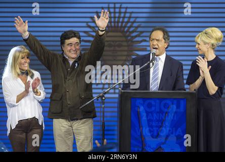 (150810) -- BUENOS AIRES, Aug. 10, 2015 -- The presidential candidate to Argentina s Presidency of ruling party Frente para la Victoria (Front for Victory), Daniel Scioli (2nd R), speaks along with his wife Karina Rabolini (R), vice-presidential candidate Carlos Zanini (2nd L), and his wife Patricia Alzua (L), at the campaign bunker, in Buenos Aires city, Argentina, early August 10, 2015. Scioli received most votes in the national primary elections in Buenos Aires on Sunday, ahead the general elections to be held on October 25th. Argentines voted Sunday in presidential primaries seen as an ear Stock Photo