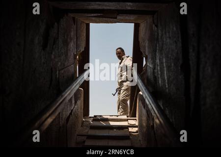 An Egyptian policeman stands guard at the entrance of the Meidum Pyramid in Beni Suef Governorate, about 100 kilometers south to Cairo, Egypt, on Aug. 10, 2015. Meidum Pyramid is thought to be built by the Pharaoh Sneferu, who continued his father Huni s work around 4,600 years ago. ) EGYPT-BENI SUEF-MEIDUM PYRAMID PanxChaoyue PUBLICATIONxNOTxINxCHN   to Egyptian Policeman stands Guard AT The Entrance of The Meidum Pyramid in Beni Suef Governorate About 100 Kilometers South to Cairo Egypt ON Aug 10 2015 Meidum Pyramid IS Thought to Be built by The Pharaoh Sneferu Who Continued His Father Huni Stock Photo