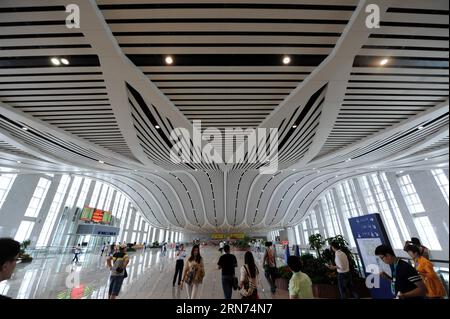 (150817) -- HARBIN, Aug. 17, 2015 -- Passengers are seen at the Qiqihar South Railway Station, northeast China s Heilongjiang Province, Aug. 17, 2015. China s northernmost high-speed railway between two cities of Harbin and Qiqihar in Heilongjiang started operation on Monday. With a designated speed of 250 kilometers per hour and eight stops, the trip from Harbin to Qiqihar was reduced from three hours to 85 minutes. The trains have been modified to adapt to temperatures as low as minus 40 degrees Celsius and resist adverse weather, such as strong winds, heavy rain, snow and fog. ) (wyo) CHINA Stock Photo