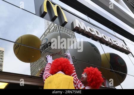 (150818) -- SAO PAULO, Aug. 18, 2015 -- Two men characterized as Ronald McDonald take part in a protest outside a McDonald s restaurant at Paulista Avenue, in Sao Paulo, Brazil, on Aug. 18, 2015. Brazilian and international unions members protested on Tuesday against the largest operator of McDonald s restaurants in Latin America alleging that the firm violated the labor laws. ) (jg) BRAZIL-SAO PAULO-SOCIETY-PROTEST RahelxPatrasso PUBLICATIONxNOTxINxCHN   150818 Sao Paulo Aug 18 2015 Two Men characterized As Ronald McDonald Take Part in a Protest outside a McDonald S Restaurant AT Paulista Ave Stock Photo