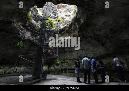 (150819) -- PUEBLA, Aug. 18, 2015 -- Tourists visit the interior of Cuexcomate volcano, at La Libertad town, in the city of Puebla, capital of Puebla state, Mexico, on Aug. 18, 2015. According to local press, the Cuexcomate volcano, whose name comes from the Nahuatl word cuexcomatl which means clay pot or place to keep , is known as the world s smallest volcano. In fact, it is not a volcano but a formation caused hundreds of years ago by a flow of hydrogen sulphide water a result of an eruption of the Popocatepetl volcano. Cuexcomate has a height of 13 meters, a diameter ranging from 8 meters Stock Photo