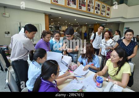 (150819) -- BANGKOK, Aug. 19, 2015 -- Relatives of injured Chinese tourists consult working staff at the King Chulalongkorn Memorial Hospital in Bangkok, capital of Thailand, on Aug. 19, 2015. A total of seven Chinese nationals have been confirmed killed in a Bangkok explosion Monday night, the Chinese Embassy in Thailand said Wednesday. Another 26 Chinese were being treated in hospitals, the embassy said. ) THAILAND-BANGKOK-EXPLOSION-KING CHULALONGKORN MEMORIAL HOSPITAL LixMangmang PUBLICATIONxNOTxINxCHN   150819 Bangkok Aug 19 2015 Relatives of Injured Chinese tourists Consult Working Staff Stock Photo