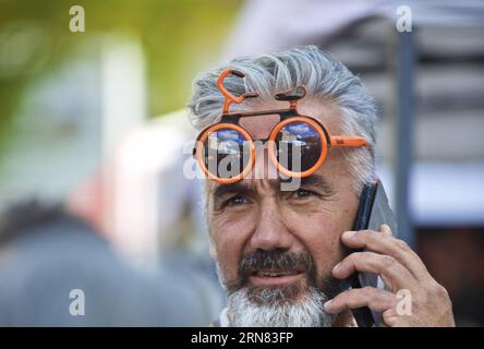 (151004) -- TUSCANY, Oct. 4, 2015 -- A bike fancier wearing a pair of bike-shape sunglasses visits the Eroica (heroic) vintage bike market in Gaiole in Chianti of Tuscany, Italy, on Oct. 3, 2015. A vintage bike market was held in Gaiole in Chianti from October 2 to October 4, as a part of the Eroica (heroic) cycling race for old bikes, which was founded in 1997, and takes place every October in Gaiole in Chianti. More than 5,500 participants from all over the world were attracted in this non professional event for classic bikes this year.) (zhf) ITALY-TUSCANY-VINTAGE BIKE MARKET JinxYu PUBLICA Stock Photo