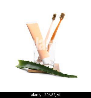 Tube of toothpaste, brushes and aloe vera leaf on white background Stock Photo