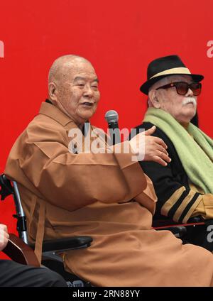 (151012) -- NANJING, Oct. 12, 2015 -- Master Hsing Yun (L), founder of the influential Fo Guang Shan Monastery in southeast China s Taiwan, speaks while sitting next to Chinese painting artist Li Chimao during the launching ceremony of an academy built for Chinese art research in a campus of Nanjing University in Nanjing, capital of east China s Jiangsu Province, Oct. 12, 2015. The academy building is named after Hsing Yun for his devotion in 2010 to the project. Located inside the building, the Li Chimao Art Museum was officially opened on Monday. ) (yxb) CHINA-NANJING-NEW COLLEGE BUILDING (C Stock Photo