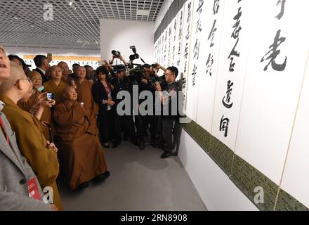 (151012) -- NANJING, Oct. 12, 2015 -- Master Hsing Yun (sitting in a wheel chair), founder of the influential Fo Guang Shan Monastery in southeast China s Taiwan, attends a calligraphy exhibition during the launching ceremony of an academy built for Chinese art research in a campus of Nanjing University in Nanjing, capital of east China s Jiangsu Province, Oct. 12, 2015. The academy building is named after Hsing Yun for his devotion in 2010 to the project. Located inside the building, the Li Chimao Art Museum was officially opened on Monday. ) (yxb) CHINA-NANJING-NEW COLLEGE BUILDING (CN) Sunx Stock Photo