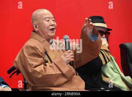 (151012) -- NANJING, Oct. 12, 2015 -- Master Hsing Yun (L), founder of the influential Fo Guang Shan Monastery in southeast China s Taiwan, speaks while sitting next to Chinese painting artist Li Chimao during the launching ceremony of an academy built for Chinese art research in a campus of Nanjing University in Nanjing, capital of east China s Jiangsu Province, Oct. 12, 2015. The academy building is named after Hsing Yun for his devotion in 2010 to the project. Located inside the building, the Li Chimao Art Museum was officially opened on Monday. ) (yxb) CHINA-NANJING-NEW COLLEGE BUILDING (C Stock Photo