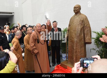 (151012) -- NANJING, Oct. 12, 2015 -- Master Hsing Yun, founder of the influential Fo Guang Shan Monastery in southeast China s Taiwan, takes part in the unveiling ceremony of his statue during the launching event of an academy built for Chinese art research in a campus of Nanjing University in Nanjing, capital of east China s Jiangsu Province, Oct. 12, 2015. The academy building is named after Hsing Yun for his devotion in 2010 to the project. Located inside the building, the Li Chimao Art Museum was officially opened on Monday. ) (yxb) CHINA-NANJING-NEW COLLEGE BUILDING (CN) SunxCan PUBLICAT Stock Photo