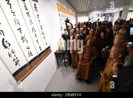 (151012) -- NANJING, Oct. 12, 2015 -- Master Hsing Yun (sitting in a wheel chair), founder of the influential Fo Guang Shan Monastery in southeast China s Taiwan, attends a calligraphy exhibition during the launching ceremony of an academy built for Chinese art research in a campus of Nanjing University in Nanjing, capital of east China s Jiangsu Province, Oct. 12, 2015. The academy building is named after Hsing Yun for his devotion in 2010 to the project. Located inside the building, the Li Chimao Art Museum was officially opened on Monday. ) (yxb) CHINA-NANJING-NEW COLLEGE BUILDING (CN) Sunx Stock Photo