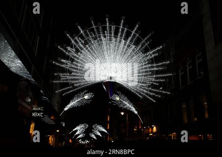 Photo taken on Nov. 19, 2014 shows the Christmas decorations on the Bond Street in London. London, located in southeastern England, is the capital of the United Kingdom. Standing on the River Thames, the city plays a key role in the world s financial, commercial, industrial and cultural fields. ) (zcc) UK-LONDON-FEATURES HanxYan PUBLICATIONxNOTxINxCHN   Photo Taken ON Nov 19 2014 Shows The Christmas decorations ON The Bond Street in London London Located in southeastern England IS The Capital of The United Kingdom thing ON The River Thames The City PLAYS a Key Role in The World S Financial Com Stock Photo
