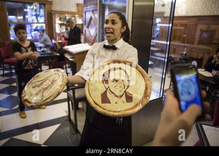 An employee shows pizzas with the faces of presidential candidates Daniel Scioli (R) and Margarita Stolbizer (L) at the Los 36 Billares pizza restaurant, in Buenos Aires city, Argentina, on Oct. 16, 2015. According to local press, the owners of the the Los 36 Billares pizza restaurant decided to create pizzas with the images of the presidential candidates, on the occasion of the elections that will take place on Oct. 25. Martin Zabala) ARGENTINA-BUENOS AIRES-POLITICS-ELECTIONS e MARTINxZABALA PUBLICATIONxNOTxINxCHN   to Employee Shows Pizzas With The Faces of Presidential Candidates Daniel Sci Stock Photo