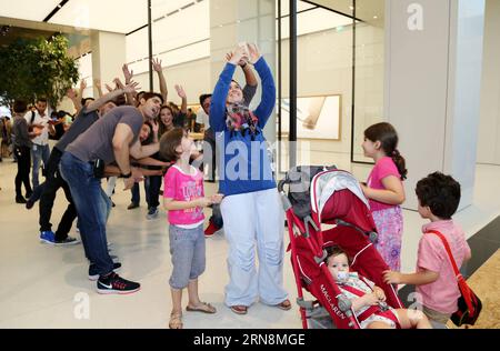 (151029) -- DUBAI, Oct. 29, 2015 -- Customers take a group selfie in an Apple Store during its opening day at a shopping mall in Dubai, United Arab Emirates, Oct. 29, 2015. Apple has opened its first retail stores in the Middle East with two shops in the United Arab Emirates. The two new stores for the Cupertino, California-based technology giant are in Dubai s Mall of the Emirates and Abu Dhabi s Yas Mall. ) UAE-DUBAI-TECHNOLOGY-APPLE LixZhen PUBLICATIONxNOTxINxCHN   Dubai OCT 29 2015 customers Take a Group Selfie in to Apple Store during its Opening Day AT a Shopping Mall in Dubai United Ara Stock Photo