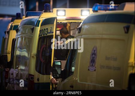 (151101) -- CAIRO, Nov. 1, 2015 -- An Egyptian ambulance worker prepares on an ambulance lining up with some 50 others outside the Zenhoum Morgue of Cairo where bodies of plane crash victims are stored, Cairo, Egypt, on Nov. 1, 2015. A total of 162 bodies of victims in the crash of Russian passenger airplane are to be airlifted later Sunday back to Russia, according to Egypt s state news agency MENA. ) EGYPT-CAIRO-RUSSIA-PLANE CRASH-MORGUE-BODIES-TRANSFERING PanxChaoyue PUBLICATIONxNOTxINxCHN   Cairo Nov 1 2015 to Egyptian Ambulance Worker Prepares ON to Ambulance Lining up With Some 50 Others Stock Photo