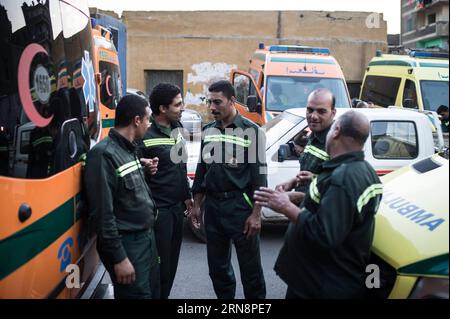 (151101) -- CAIRO, Nov. 1, 2015 -- Egyptian ambulance workers talk with each other by ambulances lining up outside the Zenhoum Morgue of Cairo where bodies of plane crash victims are stored, Cairo, Egypt, on Nov. 1, 2015. A total of 162 bodies of victims in the crash of Russian passenger airplane are to be airlifted later Sunday back to Russia, according to Egypt s state news agency MENA. ) EGYPT-CAIRO-RUSSIA-PLANE CRASH-MORGUE-BODIES-TRANSFERING PanxChaoyue PUBLICATIONxNOTxINxCHN Flugzeugabsturz in Ägypten: Überführung der Opfer   Cairo Nov 1 2015 Egyptian Ambulance Workers Talk With each Oth Stock Photo