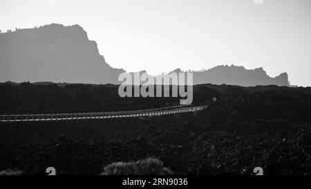 The lava fields of Las Canadas caldera of Teide volcano and TF-38 road. Tenerife. Canary Islands. Spain. Black and white. Stock Photo