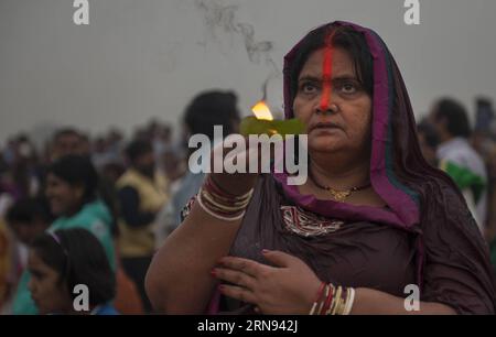 (151117) -- BARAKAR, Nov. 17, 2015 -- An Indian Hindu devotee offers prayers to the sun during the Chhath festival at Barakar, some 230km away from Kolkata, capital of eastern Indian state West Bengal, Nov. 17, 2015. Chhath festival is an ancient Hindu festival during which homage is paid to the sun and water Gods eight days after Diwali, for the longevity and prosperity of family members. ) INDIA-BARAKAR-CHHATH FESTIVAL TumpaxMondal PUBLICATIONxNOTxINxCHN   Nov 17 2015 to Indian Hindu devotee OFFERS Prayers to The Sun during The Chhath Festival AT  Some adult birds 230km Away from Kolkata Cap Stock Photo