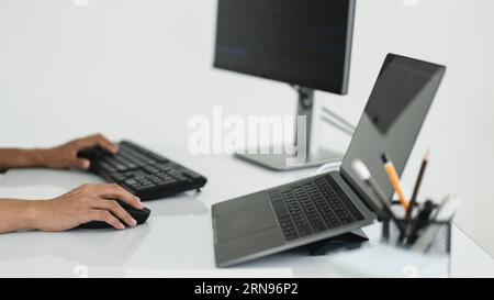 Hands of developer programmer using mouse and typing on keyboard to programming and developing web. Stock Photo