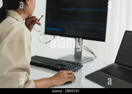 Developer programmer checking code on monitor while programming to developing web and application. Stock Photo