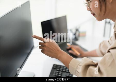 Developer programmer checking code on monitor while programming to developing web and application. Stock Photo