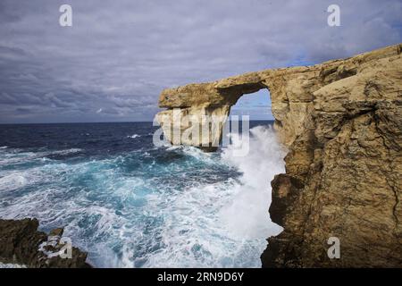 (151129) -- VALLETTA, Nov. 28, 2015 -- Photo taken on Nov. 28, 2015, in Gozo, Malta shows the view of the Azure Window. The Azure Window, Malta s famous natural landscape, is located in its second largest island Gozo. The Azure Window is one of the most photographed vistas of Malta, and is particularly spectacular during the winter, when waves crash high inside the arch. At the end of the cliff, the Azure Window is a giant doorway, through which one can admire the water expanse beyond the cliff. The sea around is very deep and of a dark blue hue, which explains why it is called the Azure Windo Stock Photo