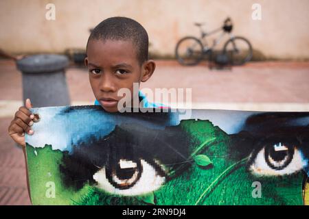 (151130) -- SANTO DOMINGO, Nov. 29, 2015 -- A boy holds a banner during a gathering in the Independence Park to support the Global Climate March in Santo Domingo, Dominican Republic, on Nov. 29, 2015. It was reported that 150 top officials from across the world will attend the summit. About 50,000 visitors, including more than 3,000 journalists are expected to take part in the United Nations 21st conference on climate, according to official data. Fran Afonso) DOMINICAN REPUBLIC-SANTO DOMINGO-SOCIETY-MARCH e FRANxAFONSO PUBLICATIONxNOTxINxCHN   151130 Santo Domingo Nov 29 2015 a Boy holds a Ban Stock Photo