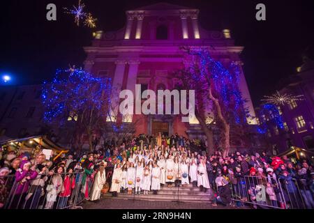 A choir of girls dressed as St. Nicholas s angels sings on the steps of the Franciscan Church of the Annunciation in Preseren Square during the annual St. Nicholas procession in Ljubljana, Slovenia, Dec. 5, 2015. The first of three good men (St.Nicholas, Santa Claus and Father Frost), who arrive in December, visited children and their families on the eve of St. Nicholas day. In the annual St. Nicholas procession in the old city center of Ljubljana, Slovenia s capital, performers dressed as St. Nicholas, his angels and devils and parkelj (Slovenian version of Krampus) greeted a big crowd of peo Stock Photo