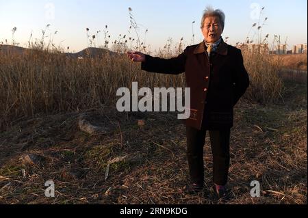 Ai Yiying, 87, survivor of the atrocious Nanjing Massacre, stands at the site where her loved ones were killed by Japanese army in Nanjing, capital of east China s Jiangsu Province, on Dec. 3, 2015. Ai Yiying survived in the Nanjing Massacre when she was 9 years old. She witnessed in a hideout that her father Ai Renyin, her uncles Ai Renbing and Ai Renlin, her cousin Ai Yisheng were forced away and killed by Japanese army. Some survivors of the Nanjing Massacre held family memorial rites for their lost relatives at the Memorial Hall of the Victims in the Nanjing Massacre by Japanese Invaders, Stock Photo