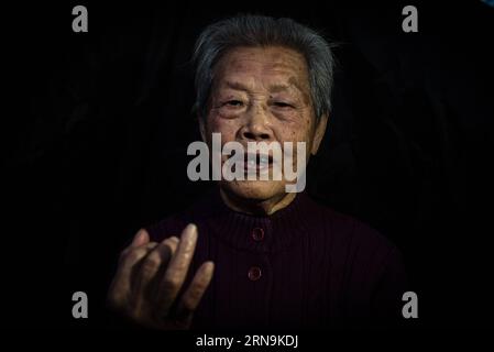 Ai Yiying, 87, survivor of the atrocious Nanjing Massacre, speaks at home in Nanjing, capital of east China s Jiangsu Province, on Dec. 3, 2015. Ai Yiying survived in the Nanjing Massacre when she was 9 years old. She witnessed in a hideout that her father Ai Renyin, her uncles Ai Renbing and Ai Renlin, her cousin Ai Yisheng were forced away and killed by Japanese army. Some survivors of the Nanjing Massacre held family memorial rites for their lost relatives at the Memorial Hall of the Victims in the Nanjing Massacre by Japanese Invaders, ahead of the national memorial day for the atrocity. A Stock Photo