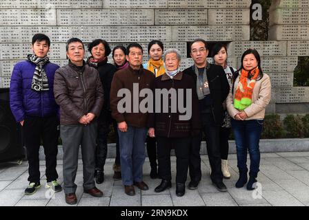 Ai Yiying (4th R), 87, survivor of the atrocious Nanjing Massacre, poses for photo with her family members at the Nanjing Massacre Memorial Hall in Nanjing, capital of east China s Jiangsu Province, on Dec. 6, 2015. Ai Yiying survived in the Nanjing Massacre when she was 9 years old. She witnessed in a hideout that her father Ai Renyin, her uncles Ai Renbing and Ai Renlin, her cousin Ai Yisheng were forced away and killed by Japanese army. Some survivors of the Nanjing Massacre held family memorial rites for their lost relatives at the Memorial Hall of the Victims in the Nanjing Massacre by Ja Stock Photo