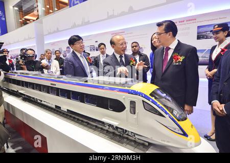 (151211) -- KUALA LUMPUR, Dec. 11, 2015 -- Malaysian Transport Minister Liow Tiong Lai (1st R, front) talks with He Huawu (C, front), chief engineer of China Railway Corporation, at the China High Speed Railway Exhibition in Kuala Lumpur, Malaysia, Dec. 11, 2015. The China High Speed Railway Exhibition, organized by China Railway Group, kicked off here on Friday to demonstrate the development and accomplishment of China s high speed railway. ) (zw) MALAYSIA-CHINA-HIGH SPEED RAILWAY-EXHIBITION ChongxVoonxChung PUBLICATIONxNOTxINxCHN   151211 Kuala Lumpur DEC 11 2015 Malaysian Transportation Min Stock Photo