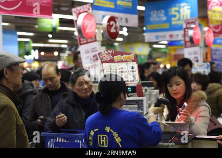 (151212) -- HANGZHOU, Dec. 12, 2015 -- A customer scans QR code to pay with Alipay at a supermarket in Hangzhou, capital of east China s Zhejiang Province, Dec. 12, 2015. China s largest online payment platform Alipay and Koubei.com, both belongs to Alibaba Group, joined hands to promote an offline sales promotion, in which customers are entitled to enjoy discount with payment by Alipay. More than 300,000 offline merchants at home and abroad took part in the event. ) (lfj) CHINA-ALIBABA-OFFLINE PROMOTION (CN) JuxHuanzong PUBLICATIONxNOTxINxCHN   151212 Hangzhou DEC 12 2015 a Customer Scans QR Stock Photo