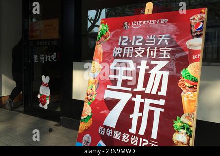 (151212) -- HANGZHOU, Dec. 12, 2015 -- A poster shows a 30-percent off sale promotion with alipay payment at the gate of a KFC store in Hangzhou, capital of east China s Zhejiang Province, Dec. 12, 2015. China s largest online payment platform Alipay and Koubei.com, both belongs to Alibaba Group, joined hands to promote an offline sales promotion, in which customers are entitled to enjoy discount with payment by Alipay. More than 300,000 offline merchants at home and abroad took part in the event. ) (lfj) CHINA-ALIBABA-OFFLINE PROMOTION (CN) JuxHuanzong PUBLICATIONxNOTxINxCHN   151212 Hangzhou Stock Photo